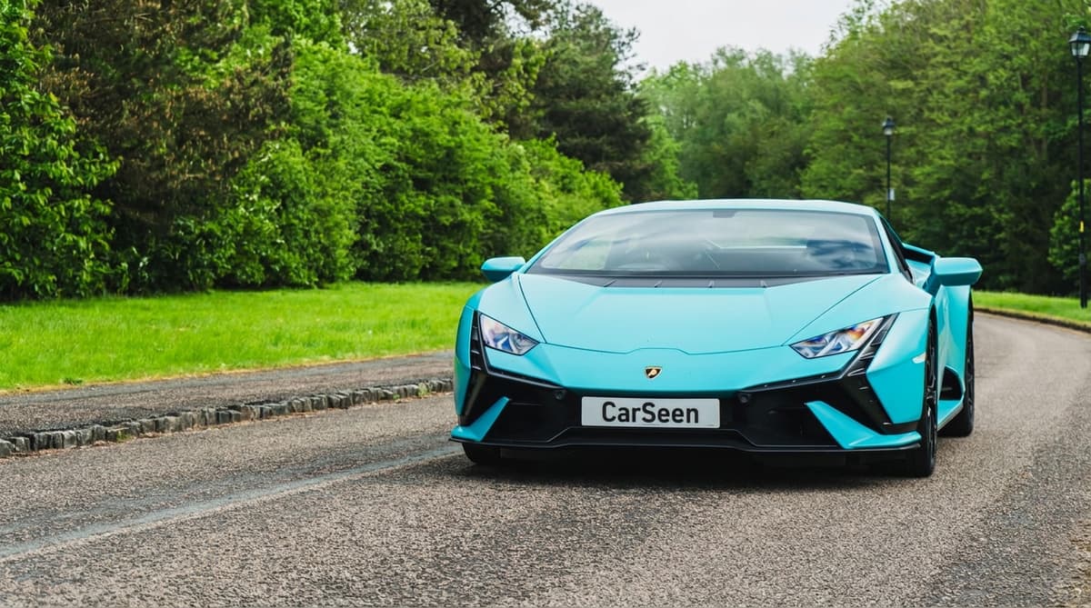 Turquoise Lamborghini Huracán Tecnica head-on at the edge of a wooded road