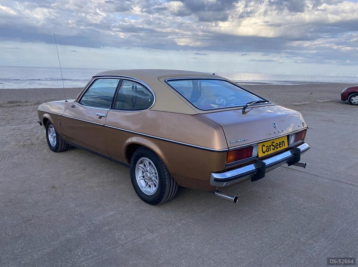 Bronze Ford Capri 3.0 Ghia photographed from the rear quarter on a beach