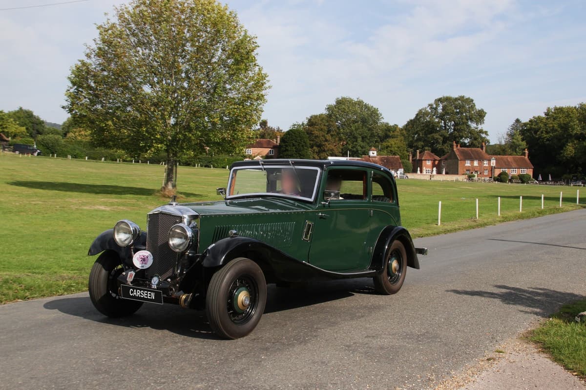 Green and black 1934 Railton Terraplane sports saloon with CarSeen plate on a village green road