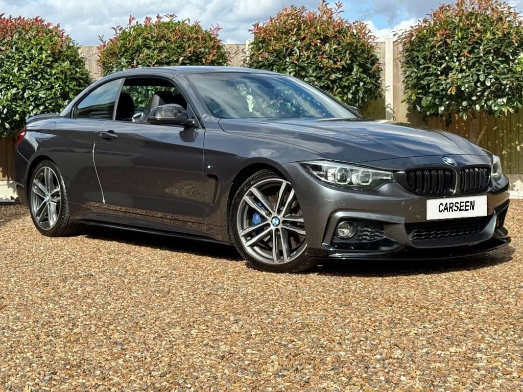 Grey BMW 4 Series Convertible M Sport with the roof up on a gravel drive