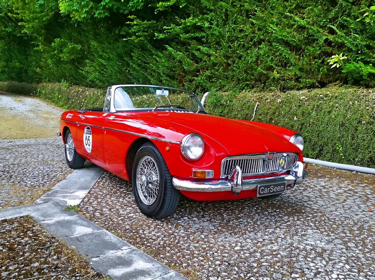 Red MG B Roadster with CarSeen registration on a cobbled drive
