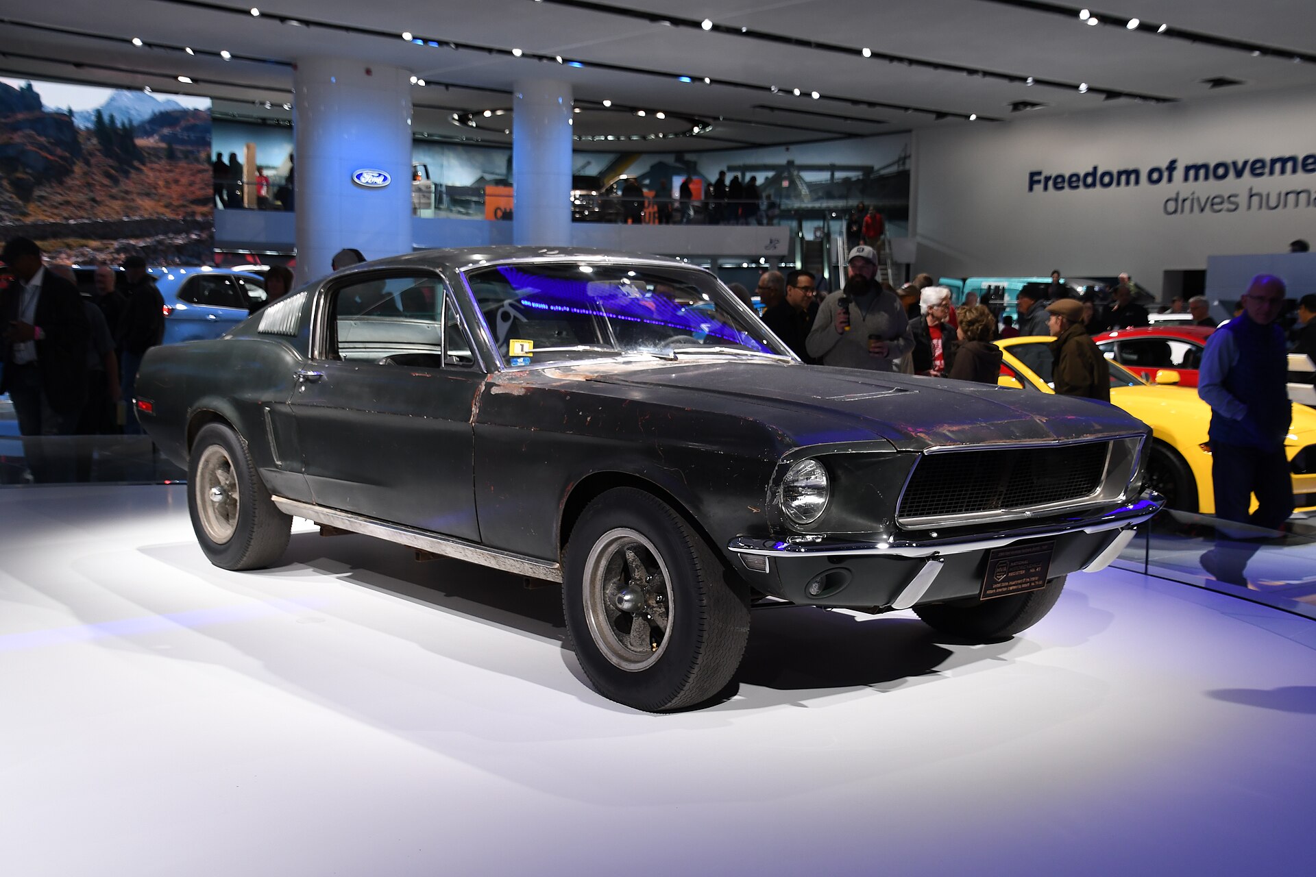Dark green 1968 Ford Mustang GT fastback on display at a motor show