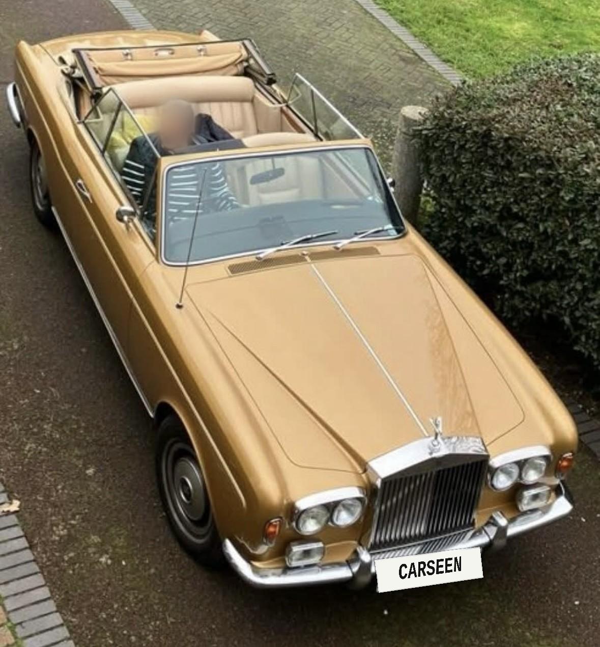 Gold Rolls-Royce Corniche convertible with cream leather and the roof down, seen from above