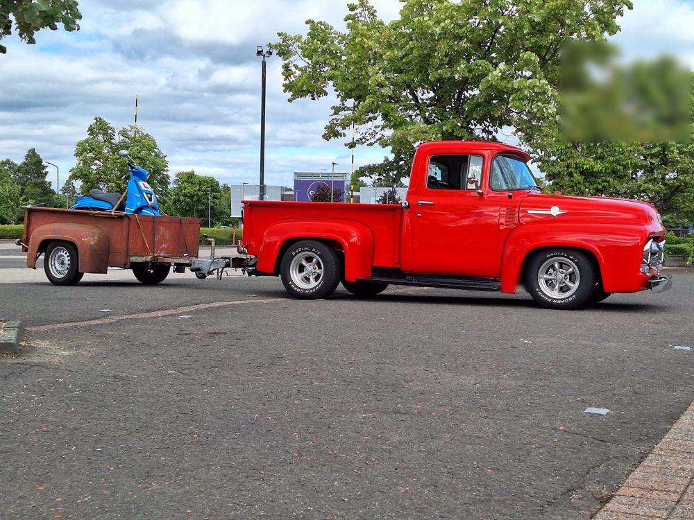 1956 Ford F100 pickup in red with matching trailer, side view