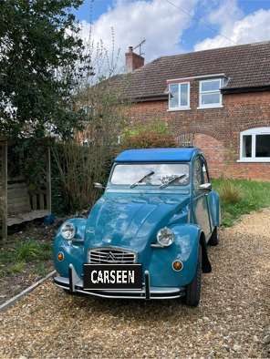 1983 Citroën 2CV in blue on a gravel drive, front three-quarter view